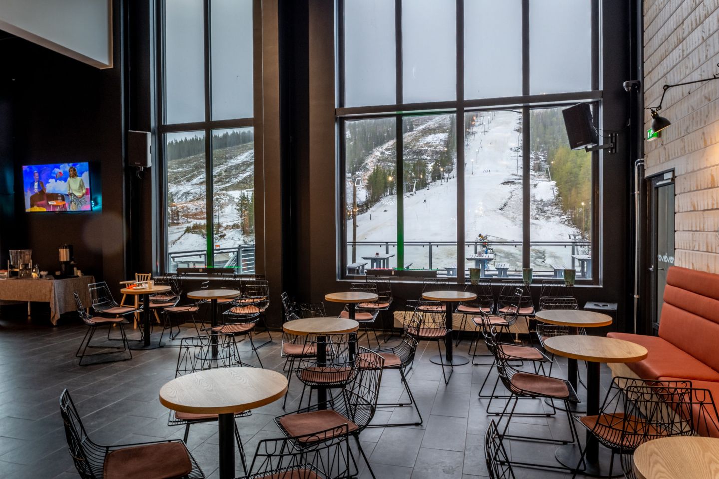 The bar looking out at the slopes at Hotel Suomutunturi, a special winter accommodation in Kemijärvi, Finland