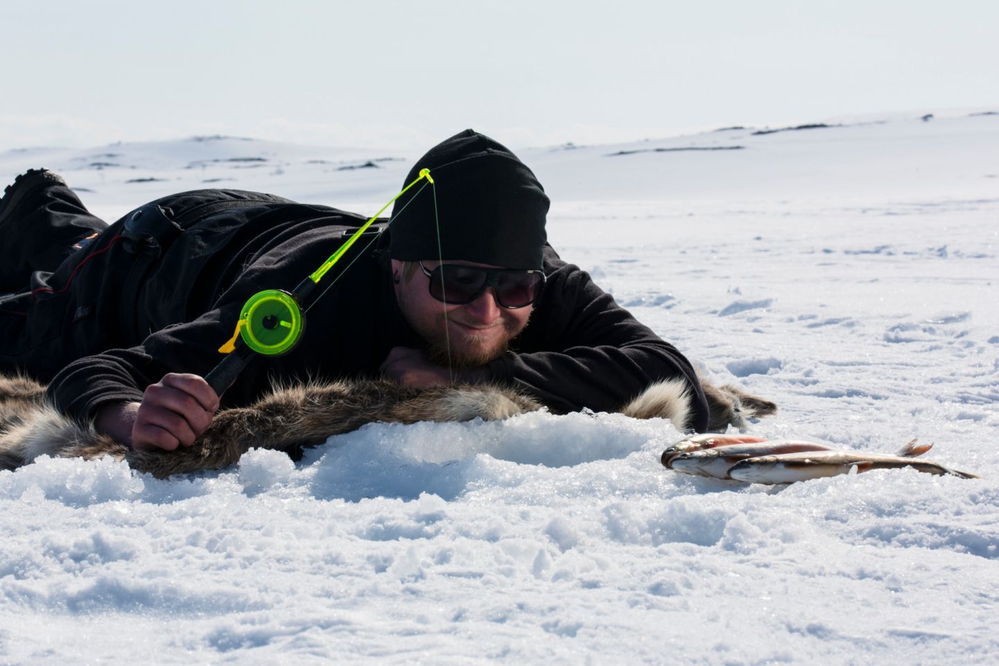 Ice-fishing in Nuorgam, Finland in winter