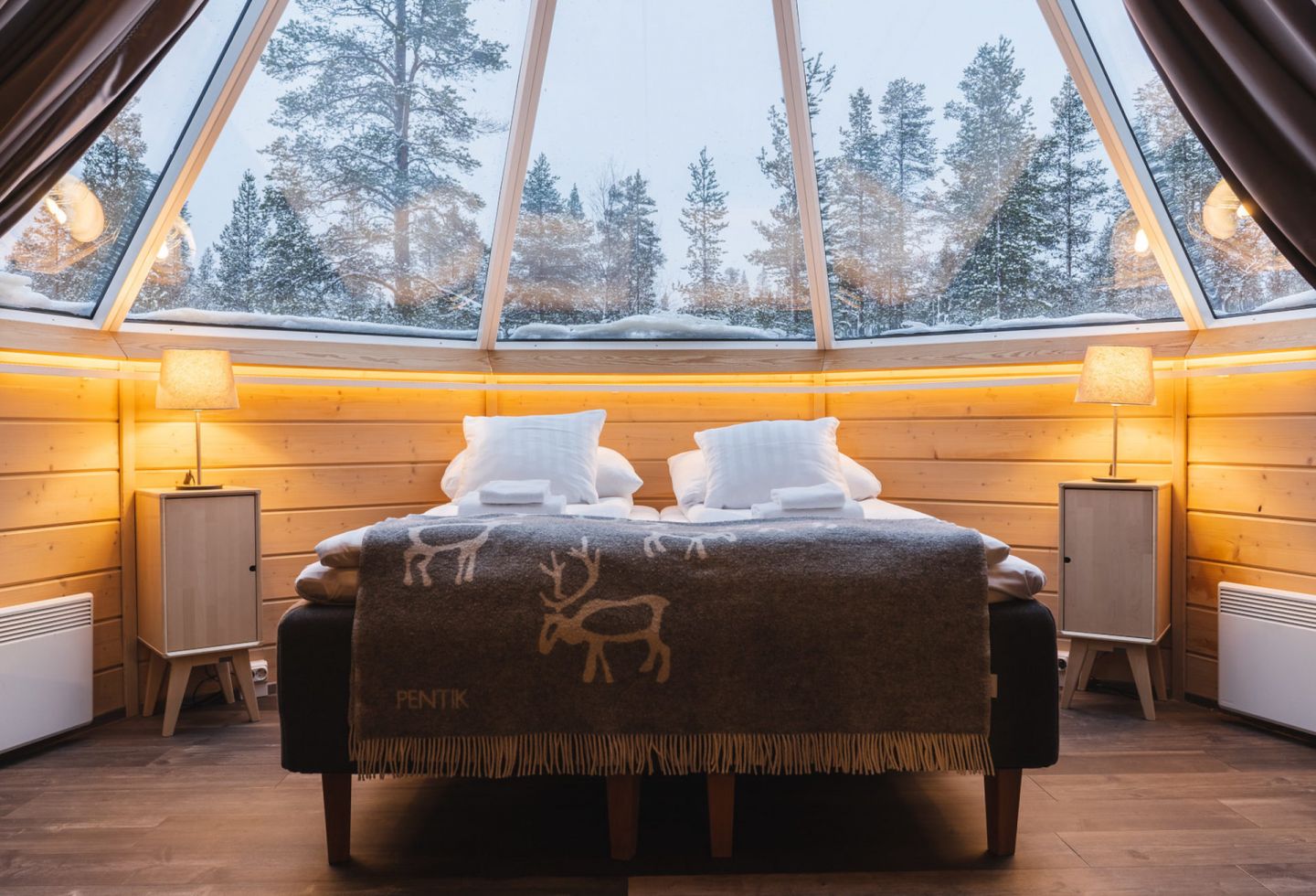 The view from the bed at Northern Lights Village, a special winter accommodation in Inari-Saariselkä, Finland