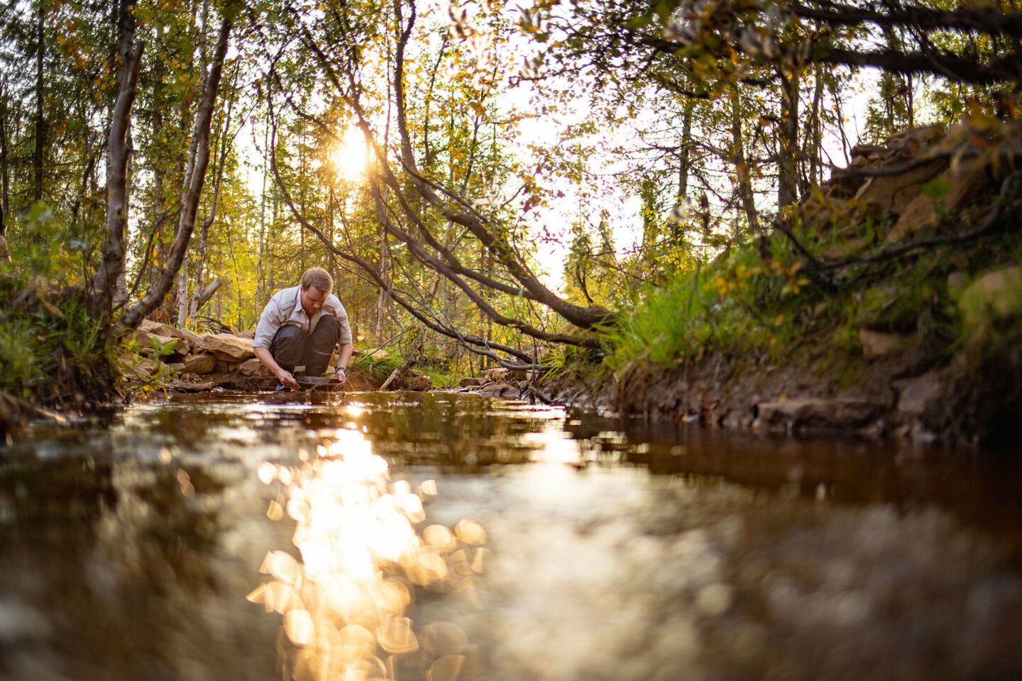 Gold panning in the river at Tankavaara Gold Village in Sodankylä, a Finnish Lapland filming location