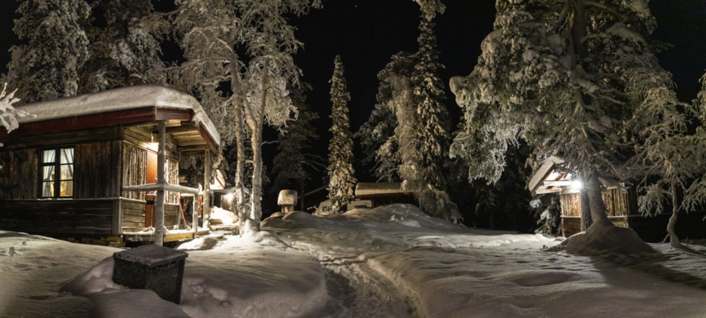 A snowy night at Tankavaara Gold Village, a special winter accommodation in Sompio, Finland