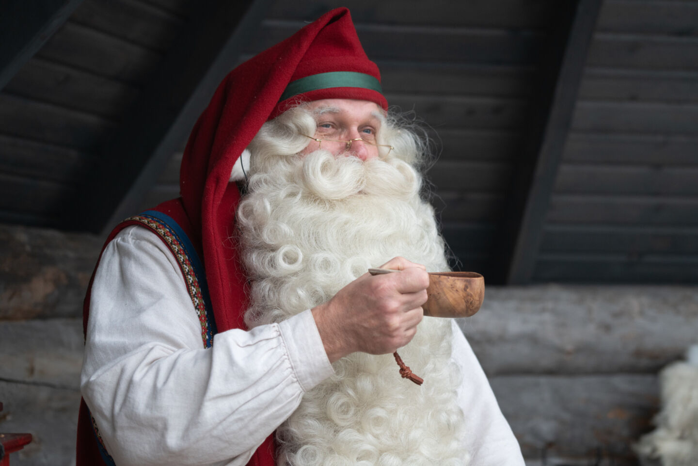 Santa Claus enjoys a cup of campfire coffee in Rovaniemi, Finland