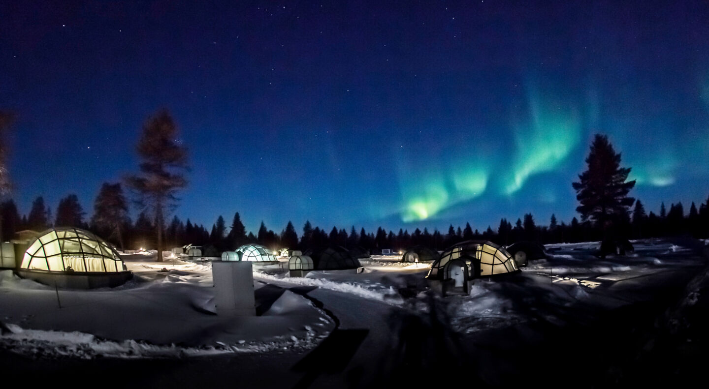 Northern Lights over the aurora bubbles accommodation in Kakslauttanen Arctic Resort in Sompio, Finland