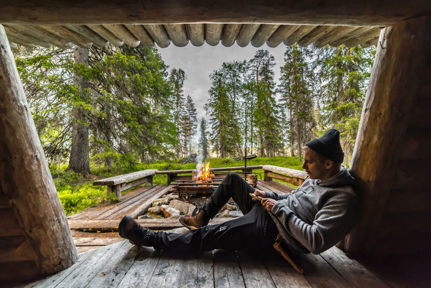 Enjoying a campfire at a laavu in Ranua, Finland