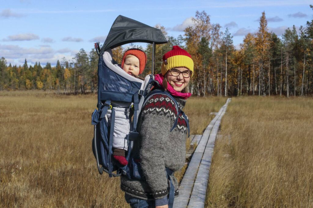 Nainen lapsi kantorinkassa syysretkellä