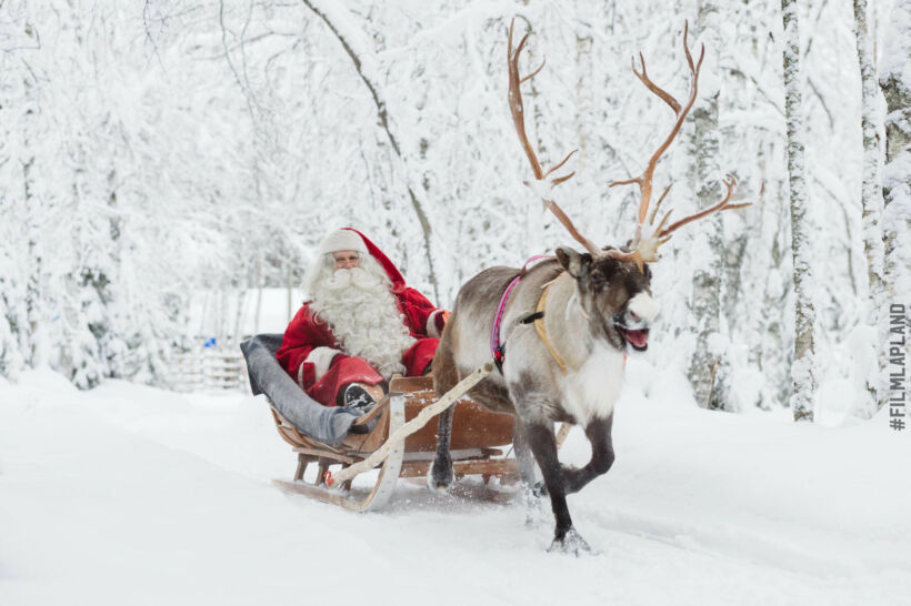 Santa enjoys a reindeer ride in Finnish Lapland