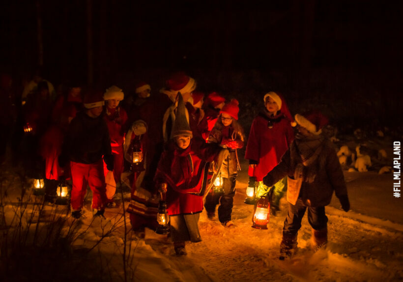 Children celebrate the dark days of Christmas in Savukoski, Finland