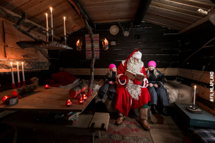 Santa visits a log cabin in Ranua, Finland