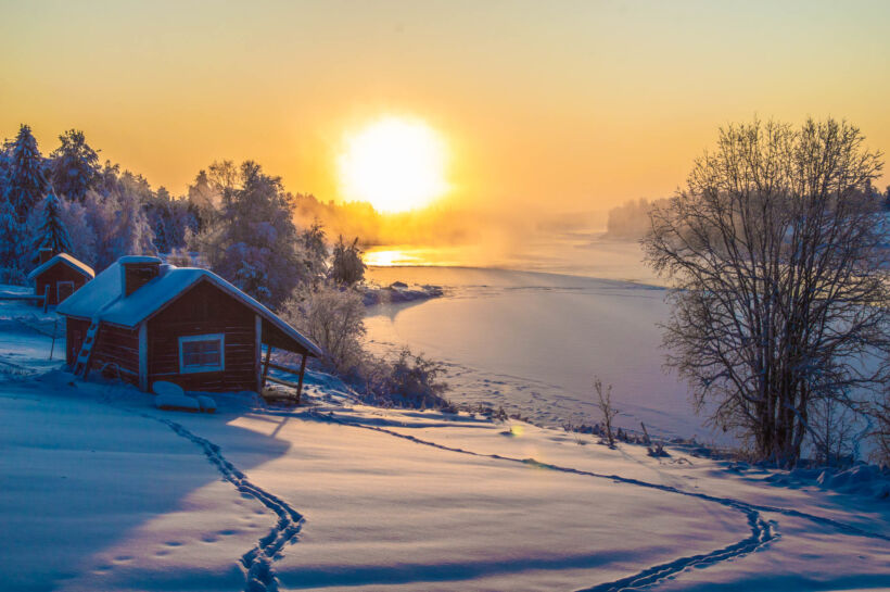 A snowy riverside cabin in Savukoski, Finland