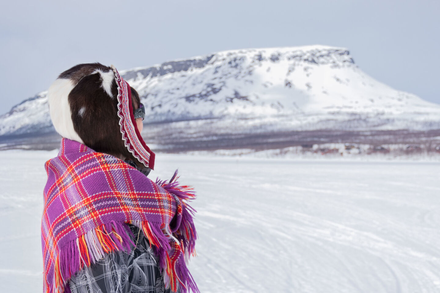A Sámi woman watches Mt. Saana fell in Enotekiö, Finland