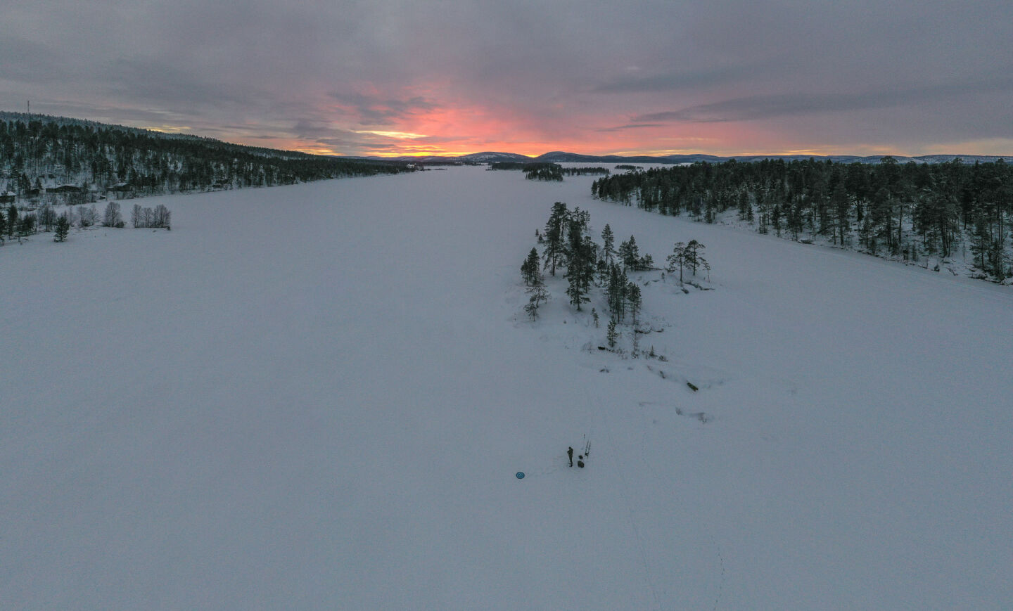 Dramatic sunset over the frozen winter lake in Inari, a film location in Finnish Lapland