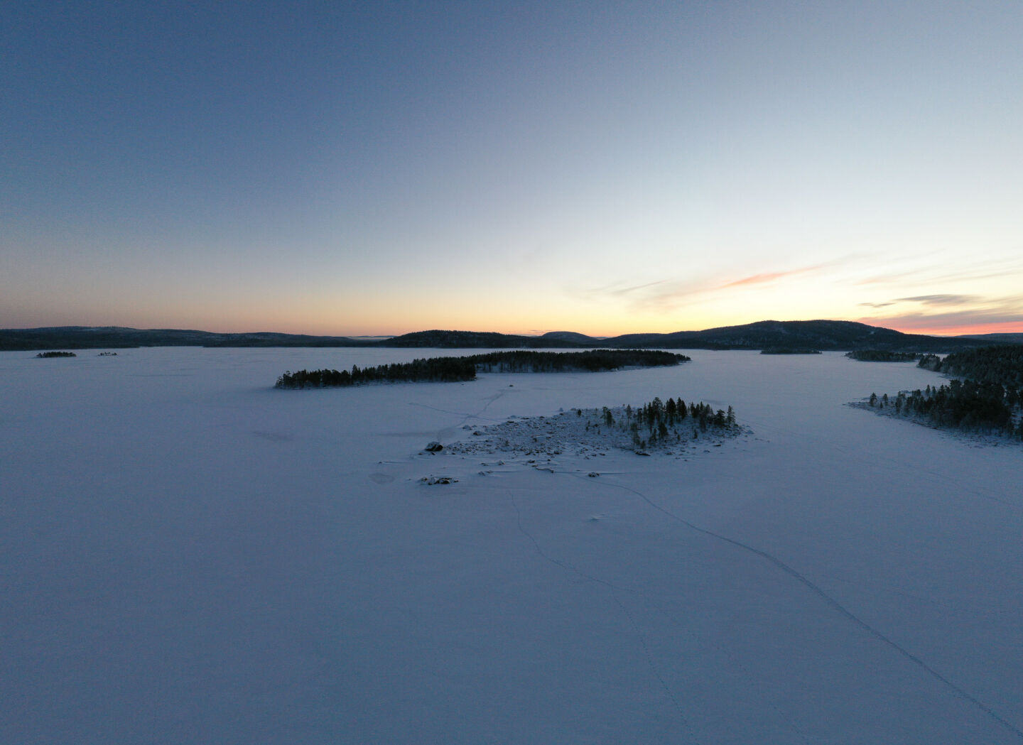 Sunrise over the frozen winter lake in Inari, a film location in Finnish Lapland
