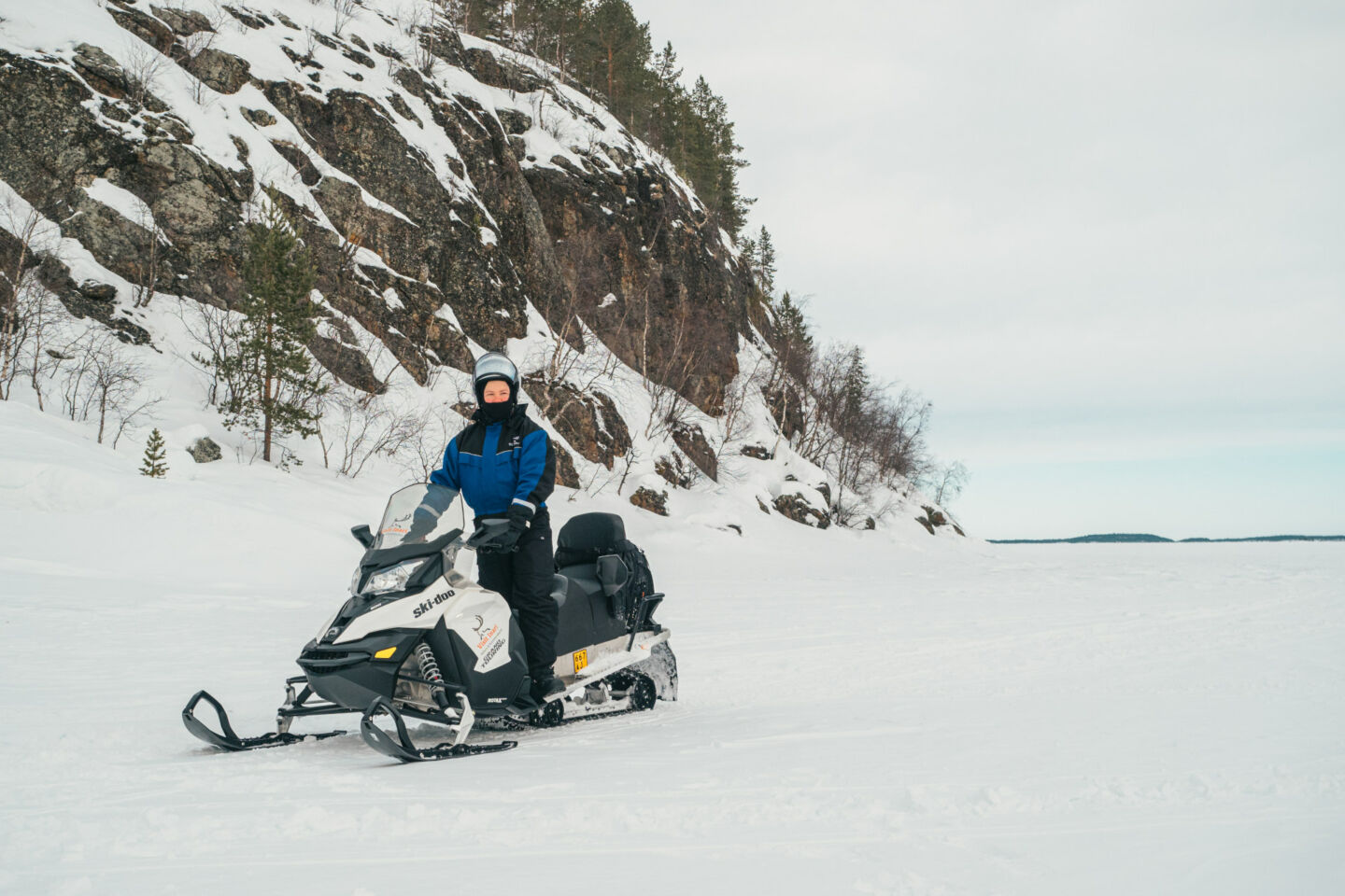 Snowmobiling across the frozen winter lake in Inari, a film location in Finnish Lapland