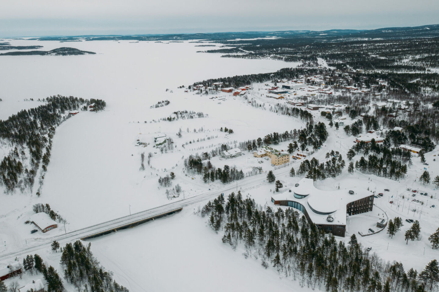 Aerial view of the village and the frozen winter lake in Inari, a film location in Finnish Lapland