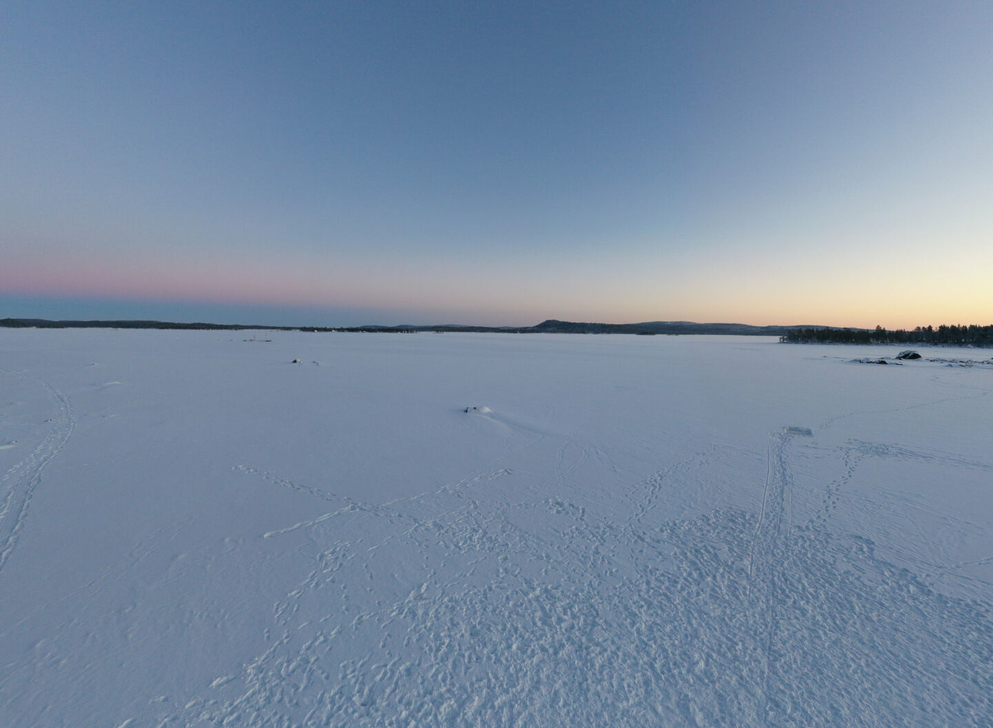 Sunrise over the frozen winter lake in Inari, a film location in Finnish Lapland