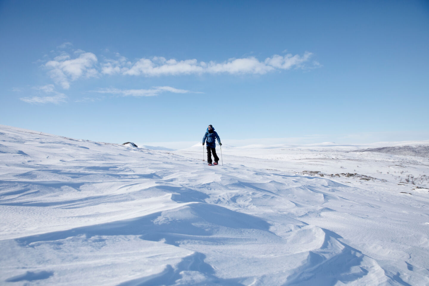 Hiking atop the snow in the tundra at Utsjoki, Finland