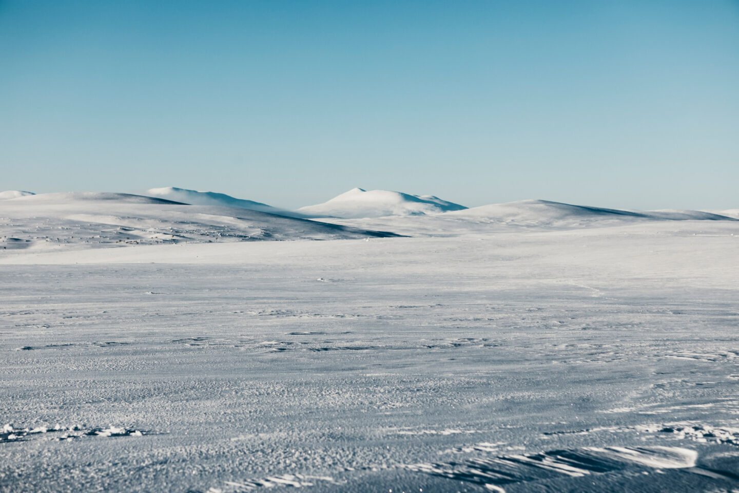 Blue skies over tundra snow in Utsjoki, Finland