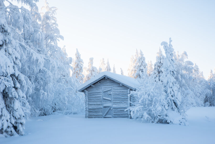 Snow-covered log buildings at Hervanvaara in Ranua, a Finnish Lapland filming location