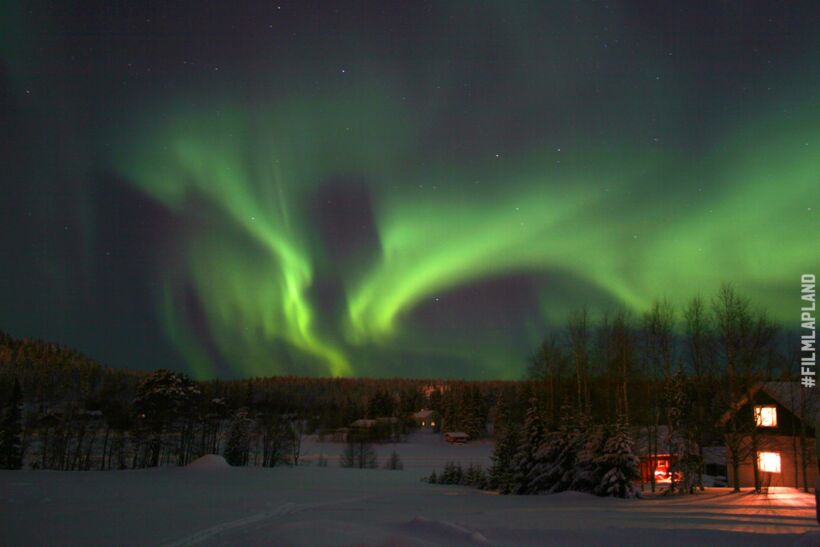 Northern Lights over a holiday village, a Finnish Lapland filming location feature