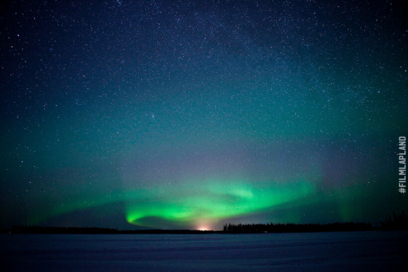 Northern Lights over a frozen lake in Sodankylä, a Finnish Lapland filming location feature