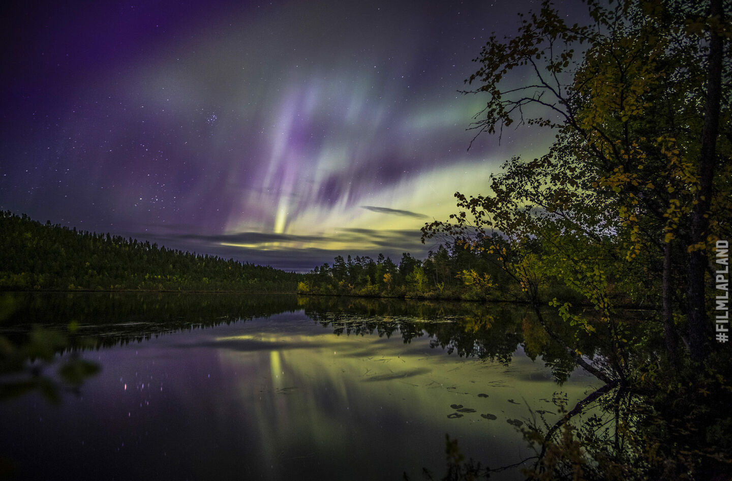 Northern Lights over a lake in Inari, a Finnish Lapland filming location feature