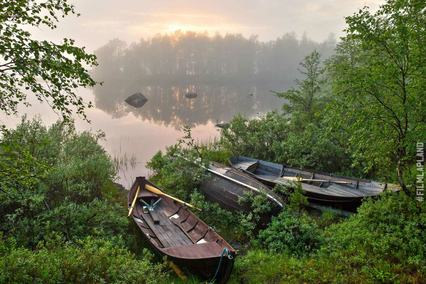 Midnight Sun over a calm lake in summer, a Finnish Lapland filming location