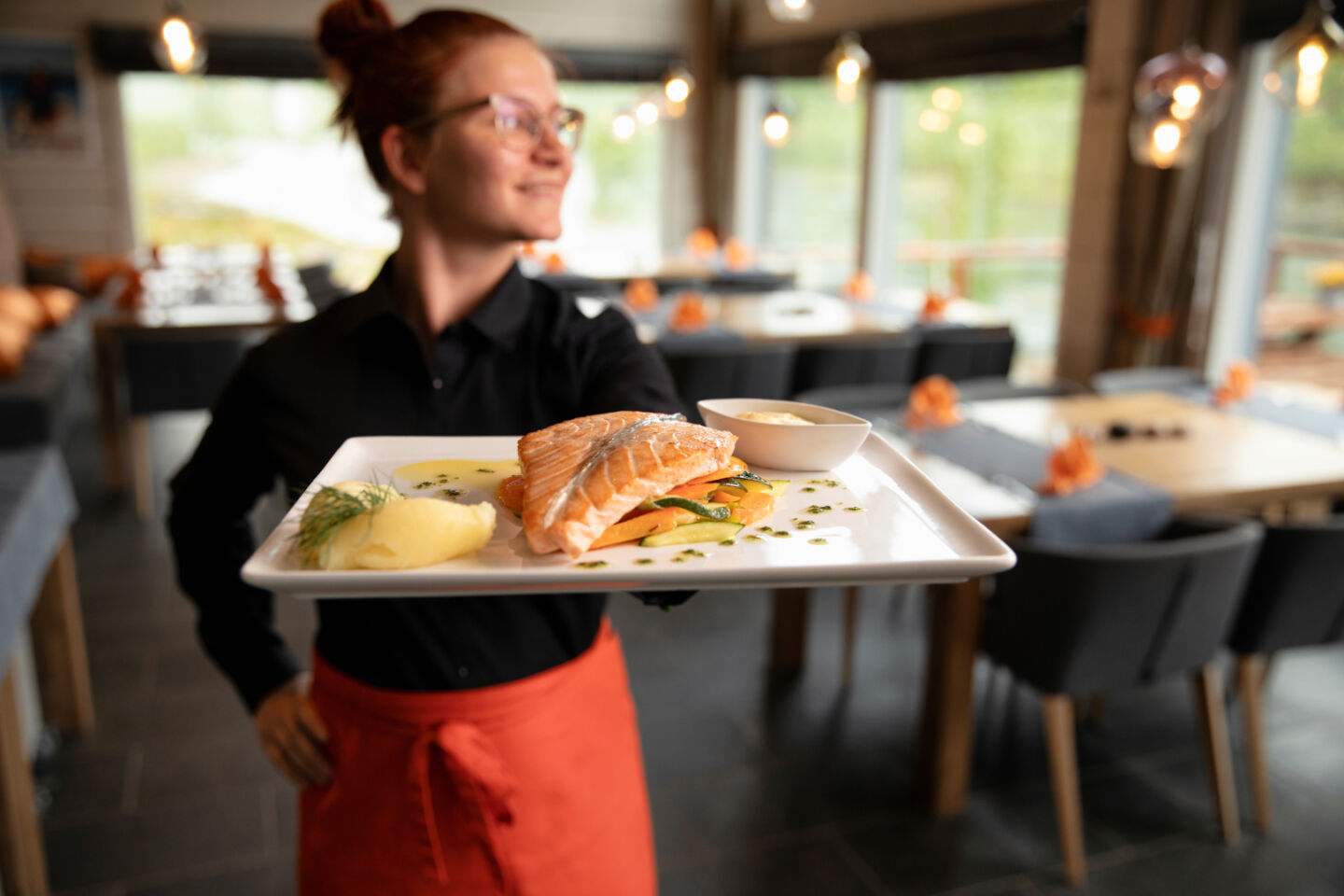 A server at a restaurant in Utsjoki. Find your own workplace in Finnish Lapland.